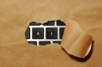 A piece of cardboard with a keyboard appearing through it by Immo Wegmann courtesy of Unsplash.