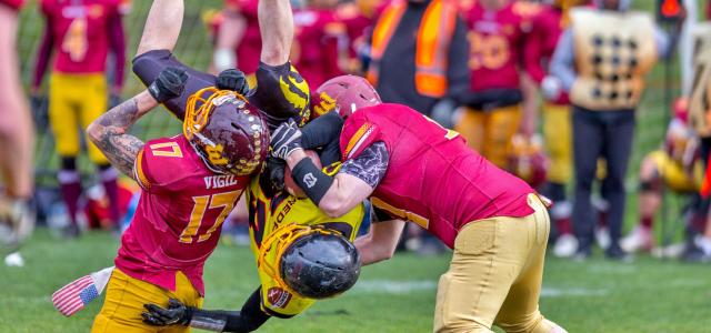 photo of three men playing football by John Torcasio courtesy of Unsplash.