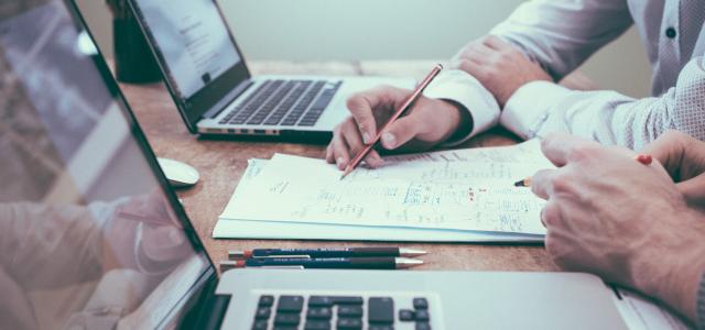 person holding pencil near laptop computer by Scott Graham courtesy of Unsplash.