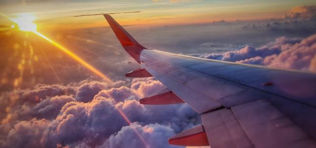 Picture of an airplane wing and sunset view